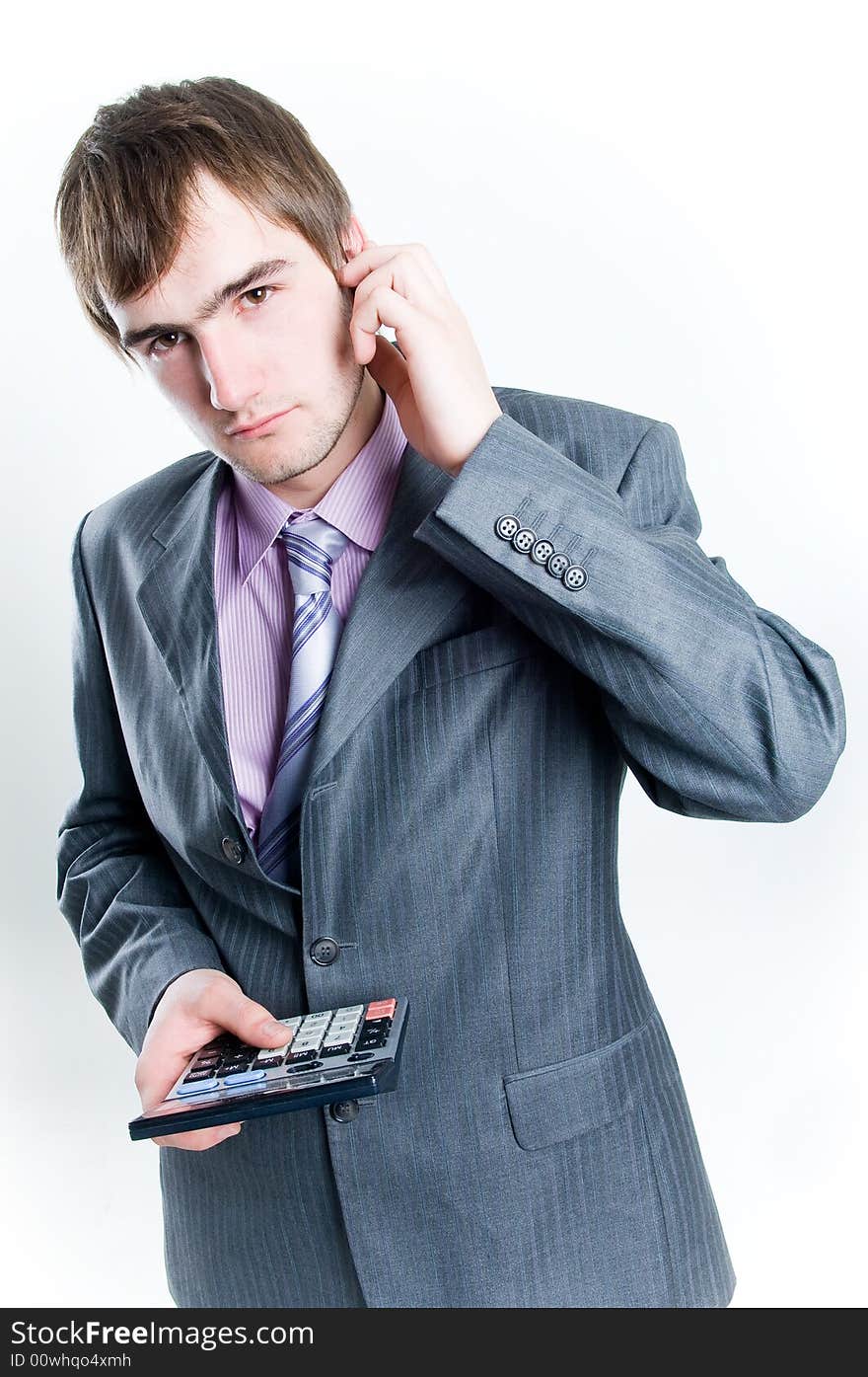 Serious looking businessman with calculator