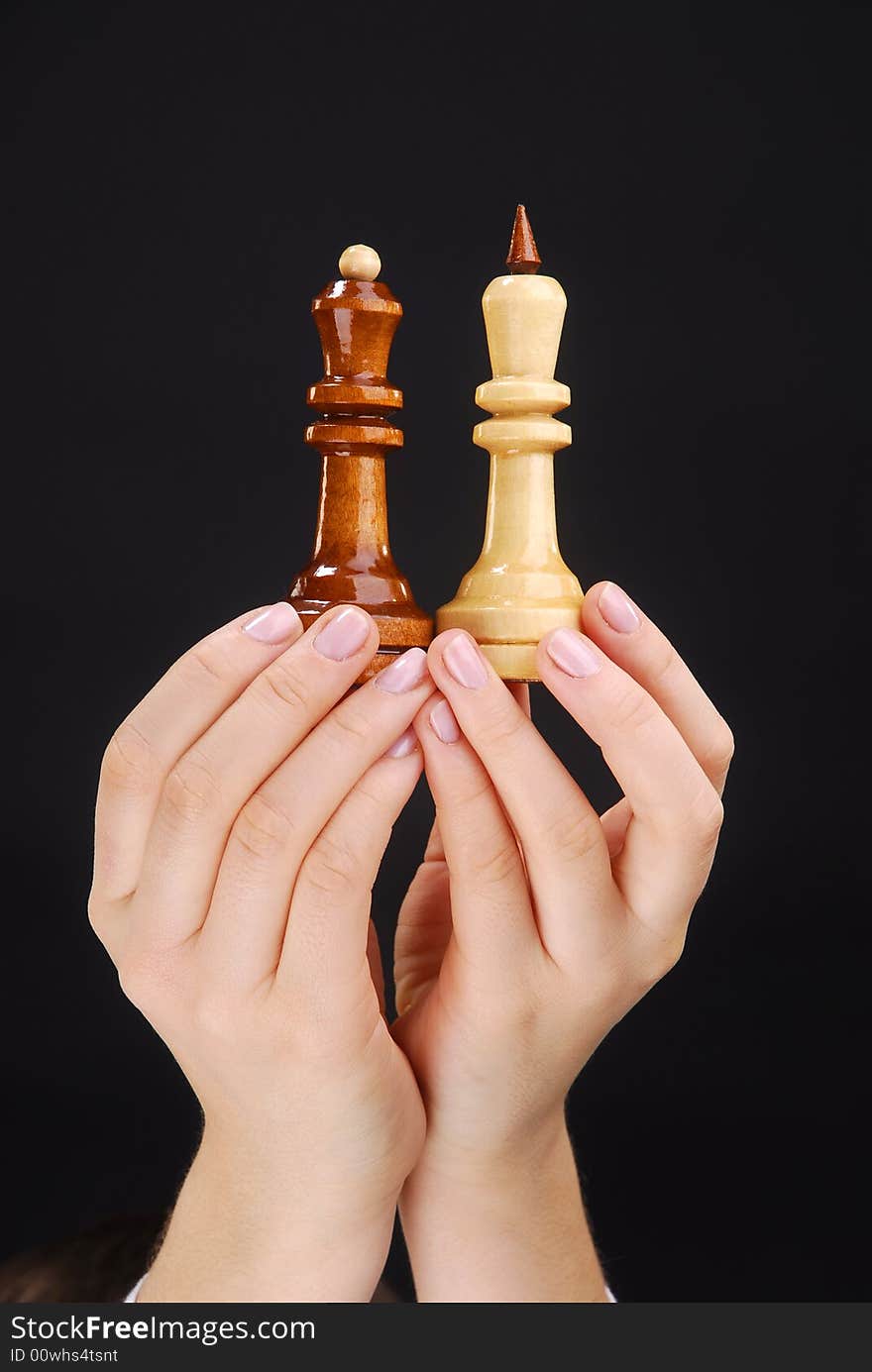 Two hands with chesspieces