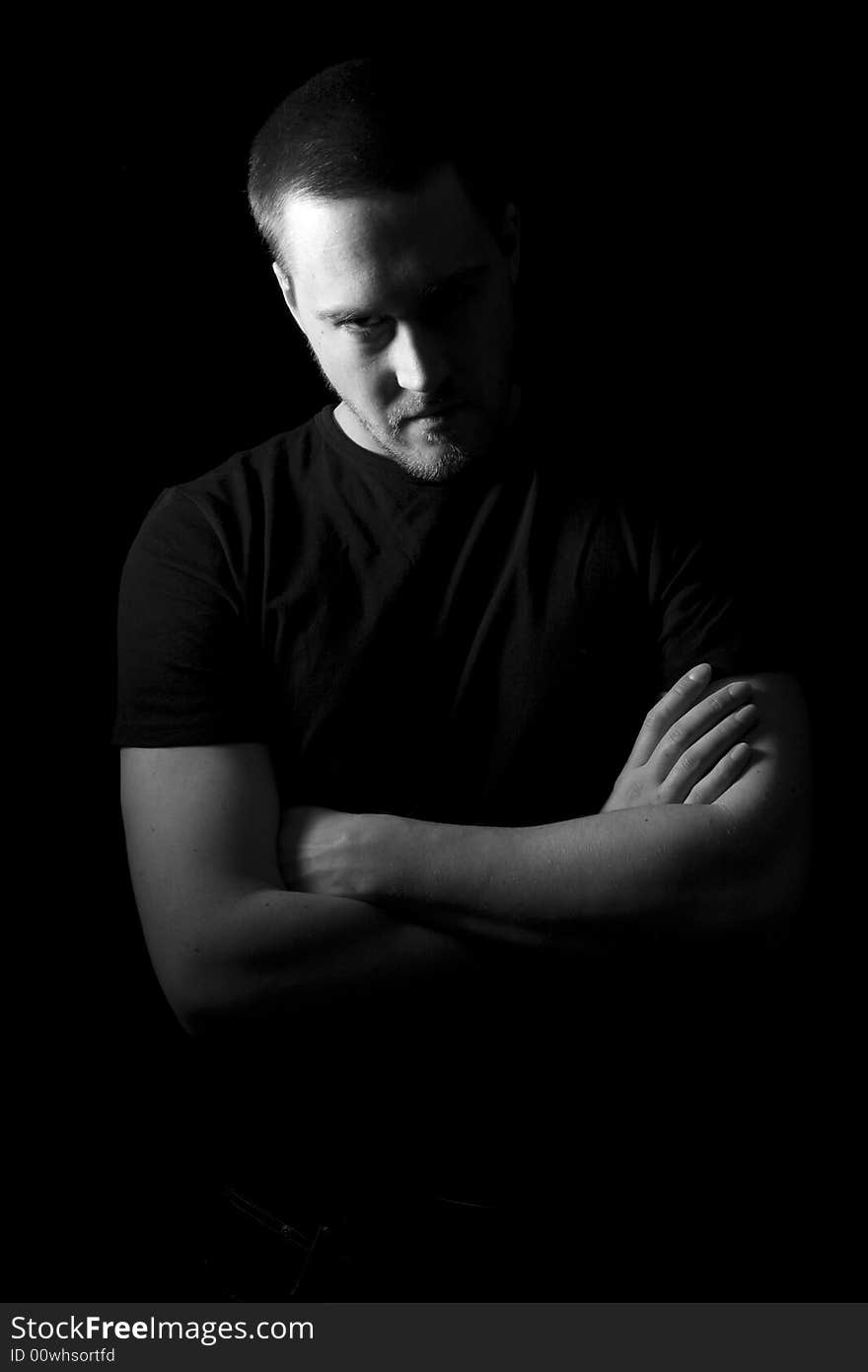 Portrait of a handsome young man in black and white (black background)