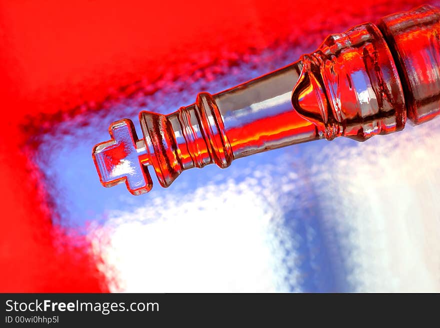 Close-up of glass chess king against multi colored abstract background. Close-up of glass chess king against multi colored abstract background