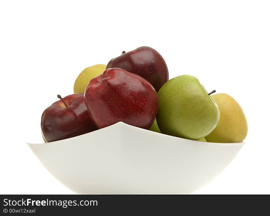 Red, yellow, green apples in a vase over white. Red, yellow, green apples in a vase over white