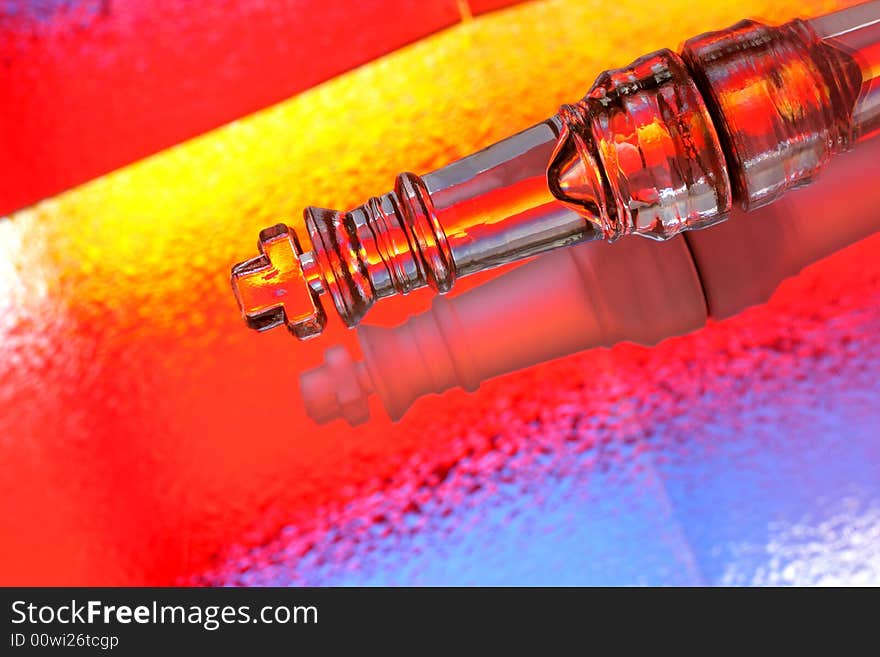 Close-up of opposing glass chess kings against multi colored abstract background. Close-up of opposing glass chess kings against multi colored abstract background