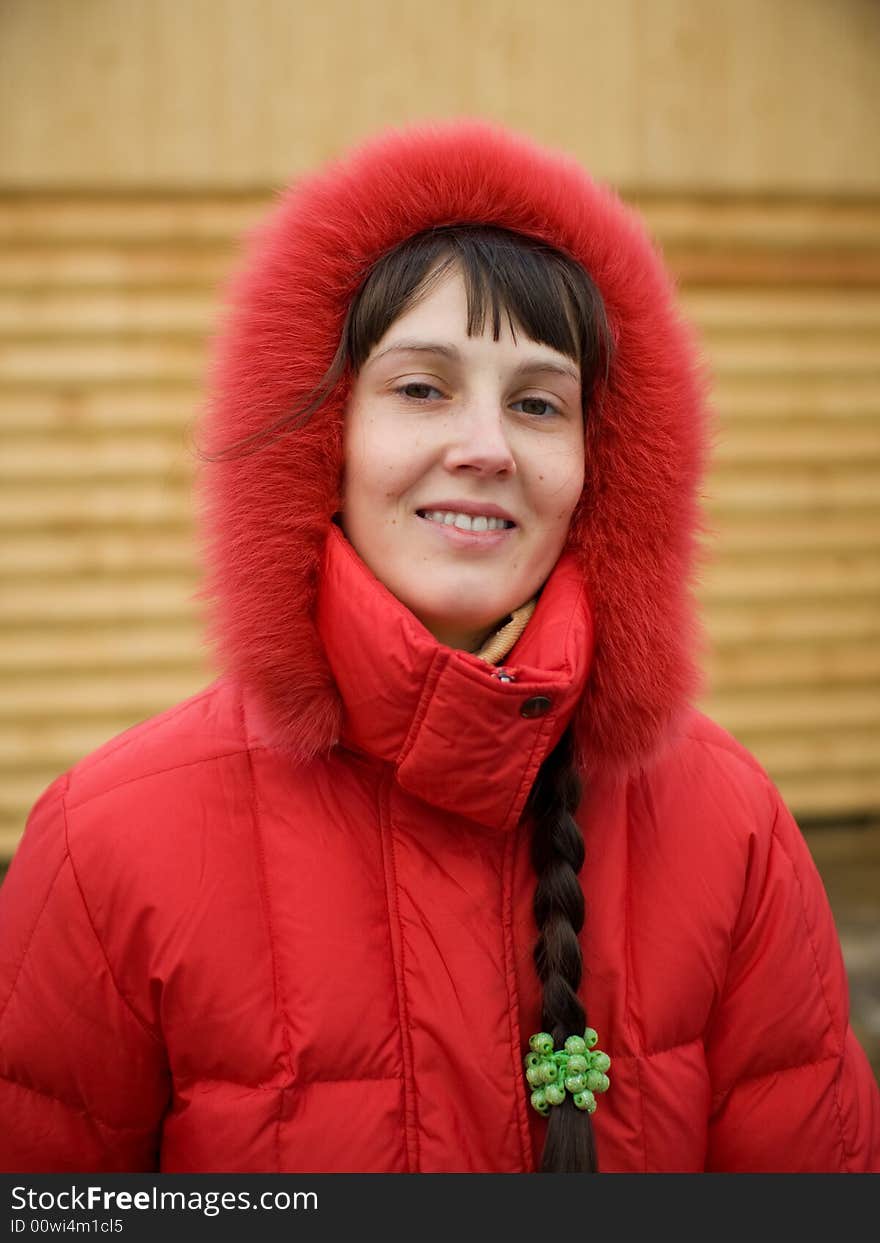 Cute Winter Girl and Wooden Wall on Background