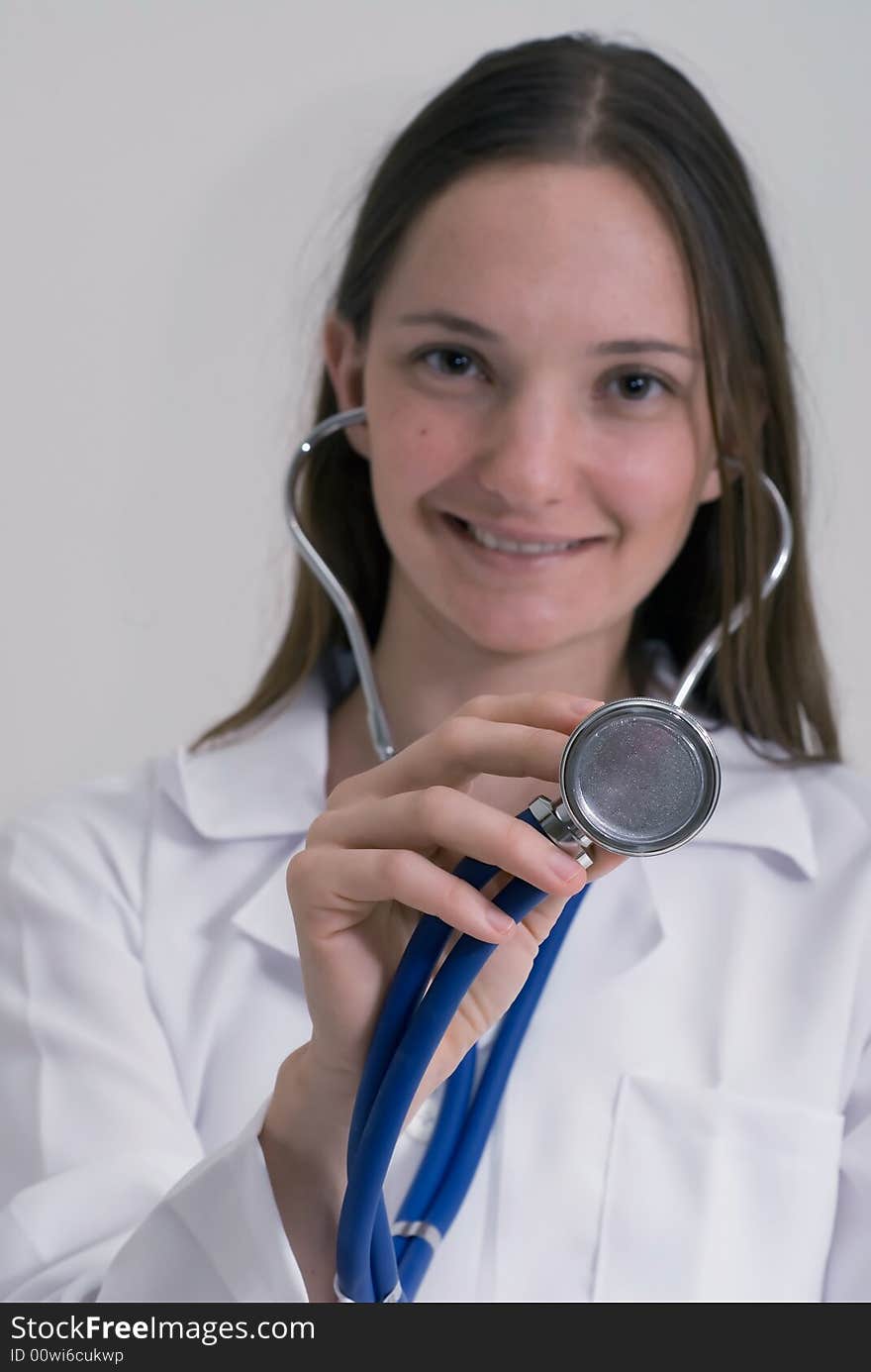 An isolated shot of a medical intern smiling and holding a stethoscope. An isolated shot of a medical intern smiling and holding a stethoscope.