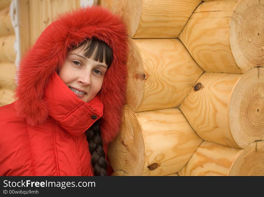 Cute Winter Girl and Wooden Wall on Background