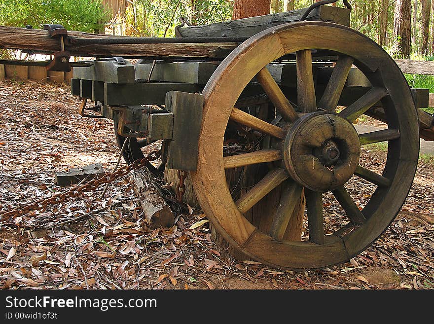 This large wheel is made entirely of wood and is attached to a cart. It also shows the wooden braking system. This large wheel is made entirely of wood and is attached to a cart. It also shows the wooden braking system.