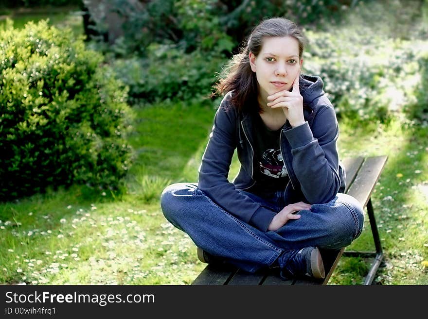 Woman sitting on a bench in the nature. Woman sitting on a bench in the nature