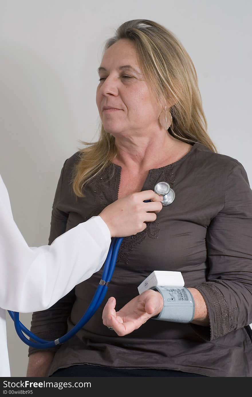 An isolated shot of a woman being examined by doctor/nurse. An isolated shot of a woman being examined by doctor/nurse.