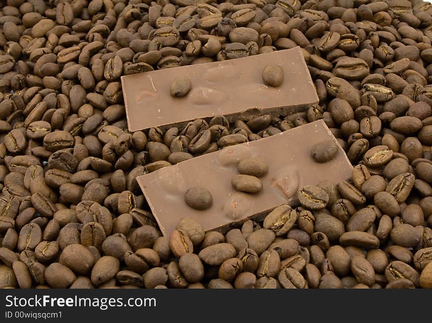 Chocolate and coffee beans isolated on white. Chocolate and coffee beans isolated on white