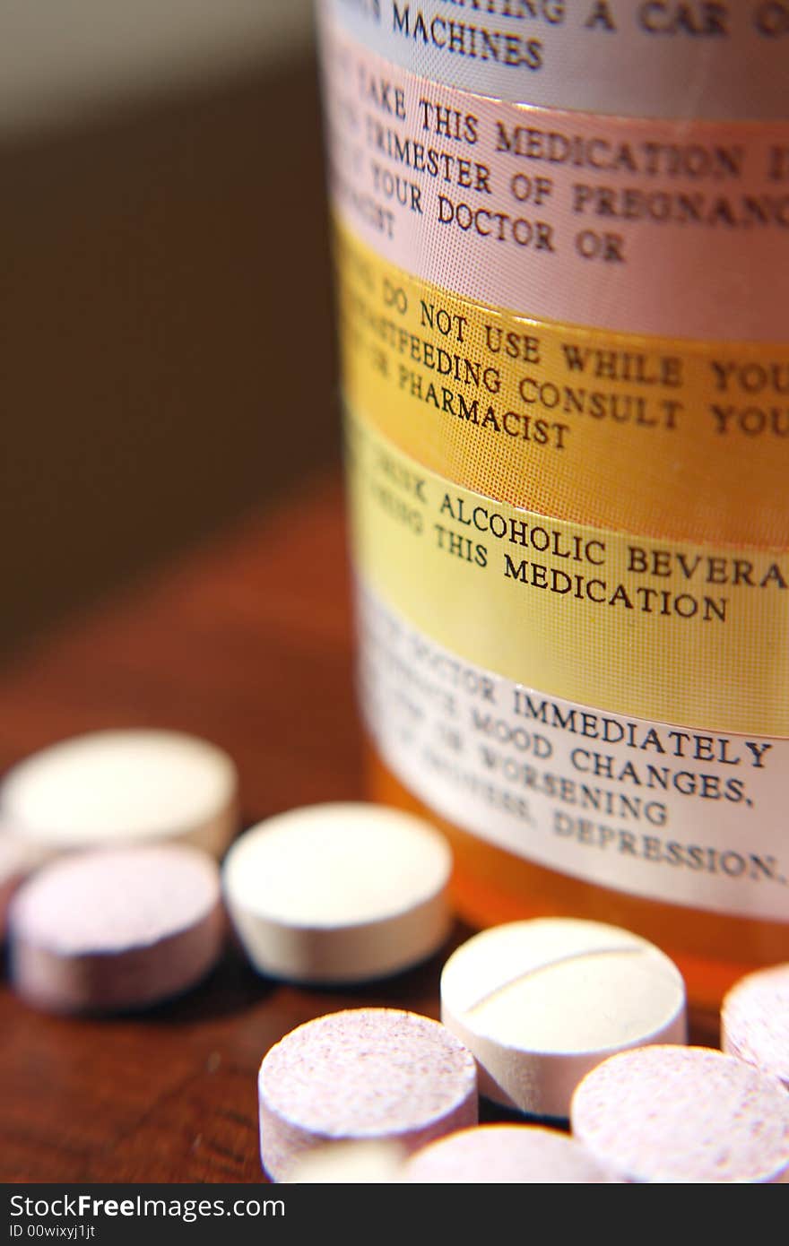 Close up of various pills with pill bottle