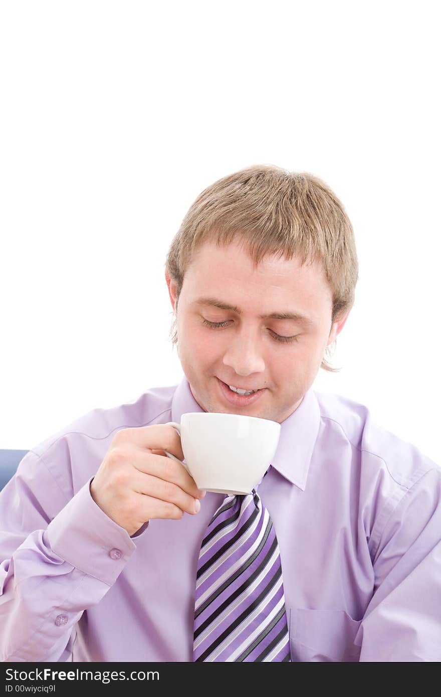 Young businessman enjoying a nice warm cup of coffee at break. . Isolated on white background. Young businessman enjoying a nice warm cup of coffee at break. . Isolated on white background