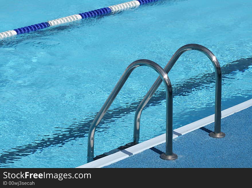 Metal chromeplated ladder in open pool. Metal chromeplated ladder in open pool