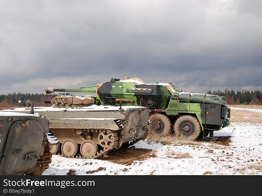 Three military vehicles are guarding territory against the enemy. Three military vehicles are guarding territory against the enemy