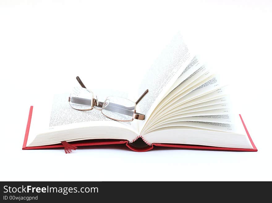 Red book and glasses on white background