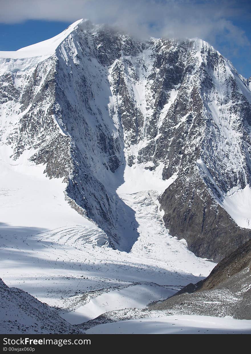 high snow-covered mountain in the cloud