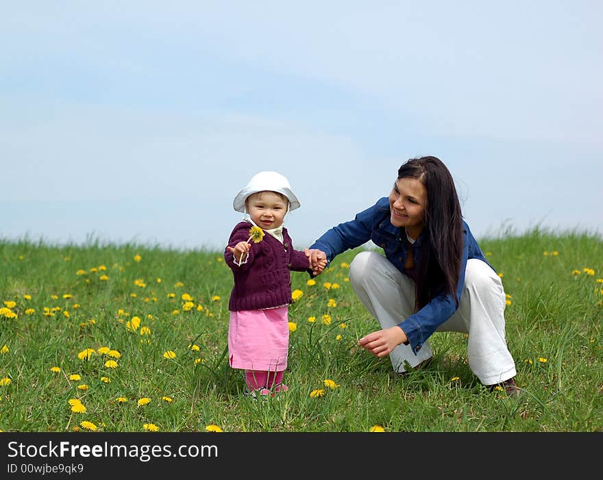 Mother and baby together on green meadow. Mother and baby together on green meadow