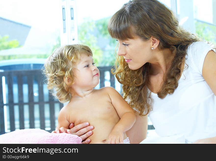 High key portrait of happy mother with baby. High key portrait of happy mother with baby