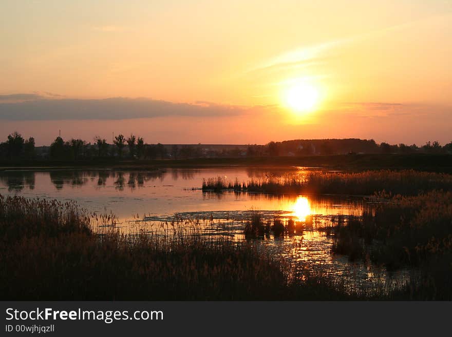 Sunset on the lake with lake silhouette