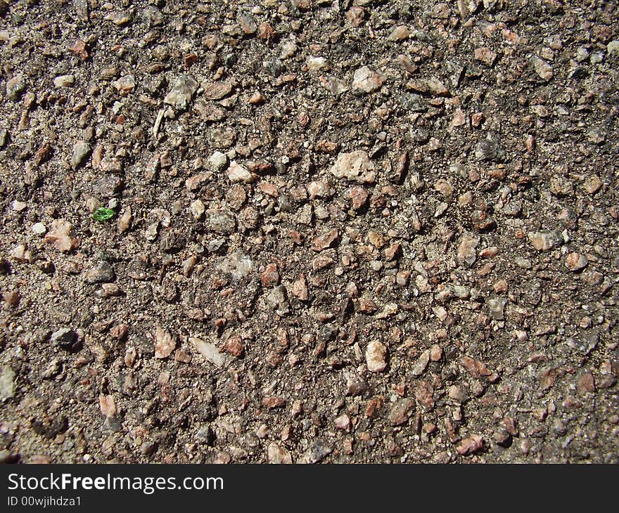 Many grey stones and one green