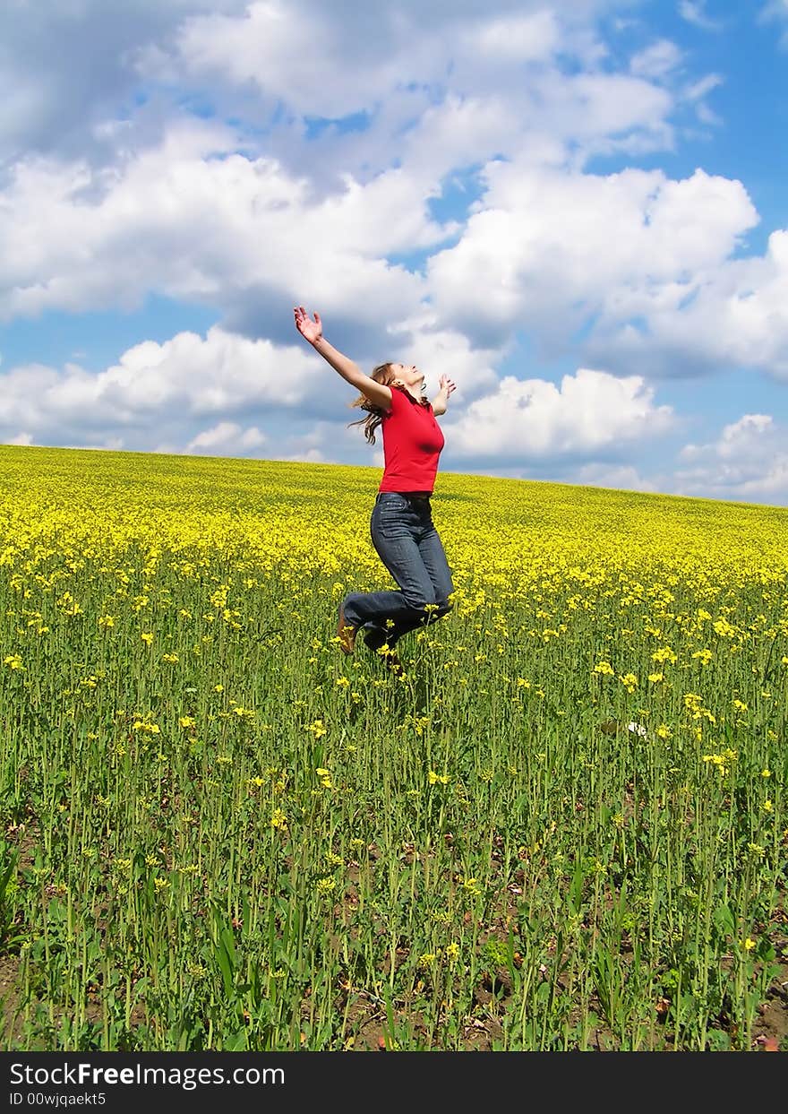 Young girl jumping in filed. Young girl jumping in filed