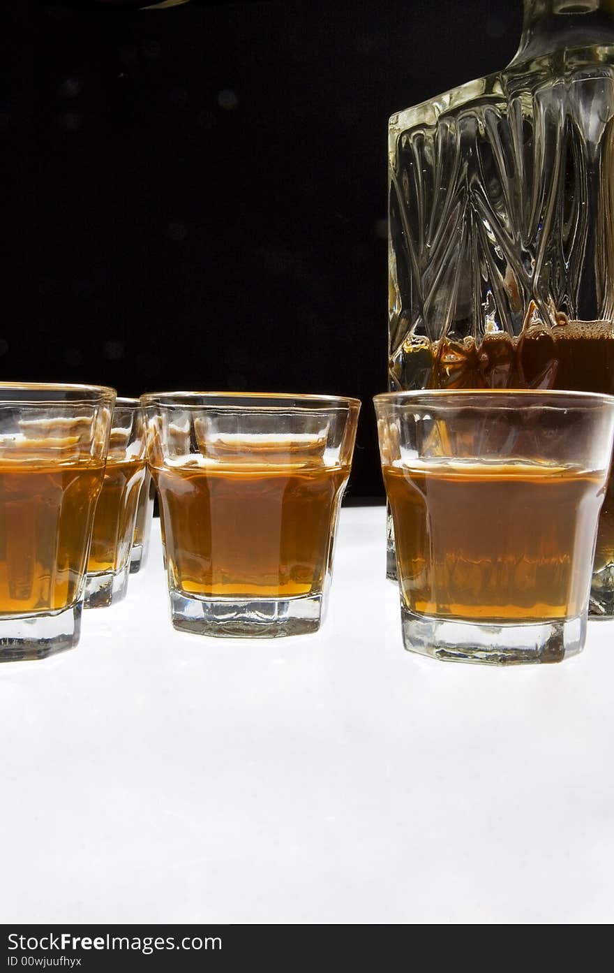 Glass of whisky isolated over white and black background