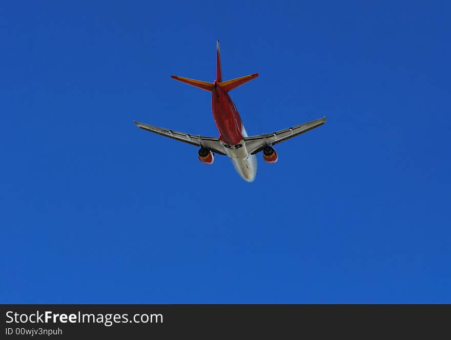 Red plane on the clear, blue sky. Red plane on the clear, blue sky.