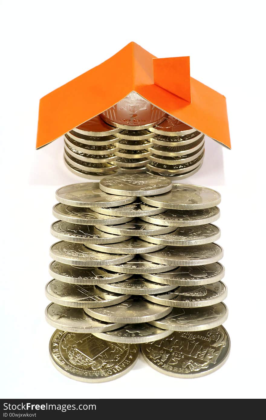 Coins folded as house against the white background. Coins folded as house against the white background