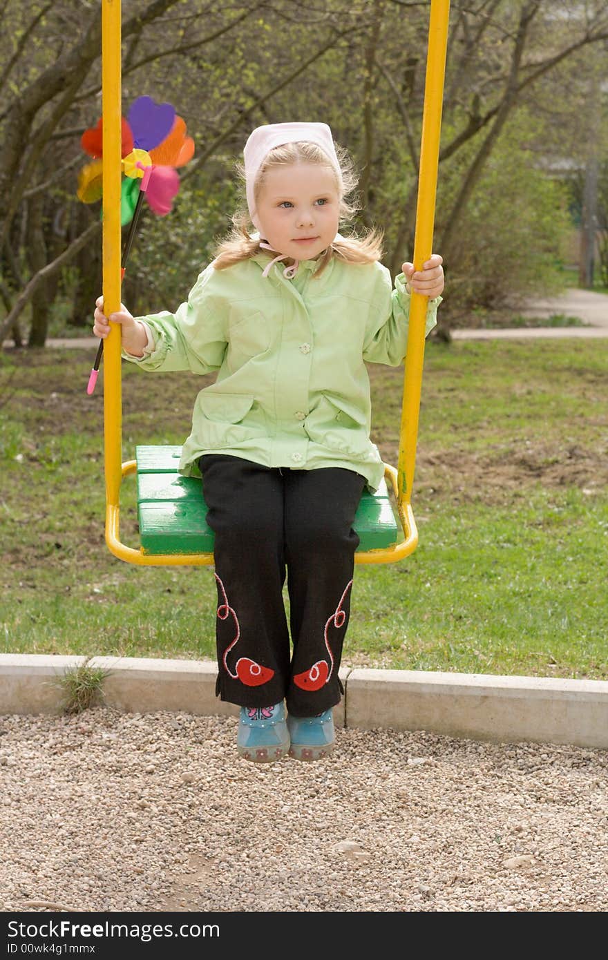 Young girl in the cheen clothes swinging with color vane. Young girl in the cheen clothes swinging with color vane