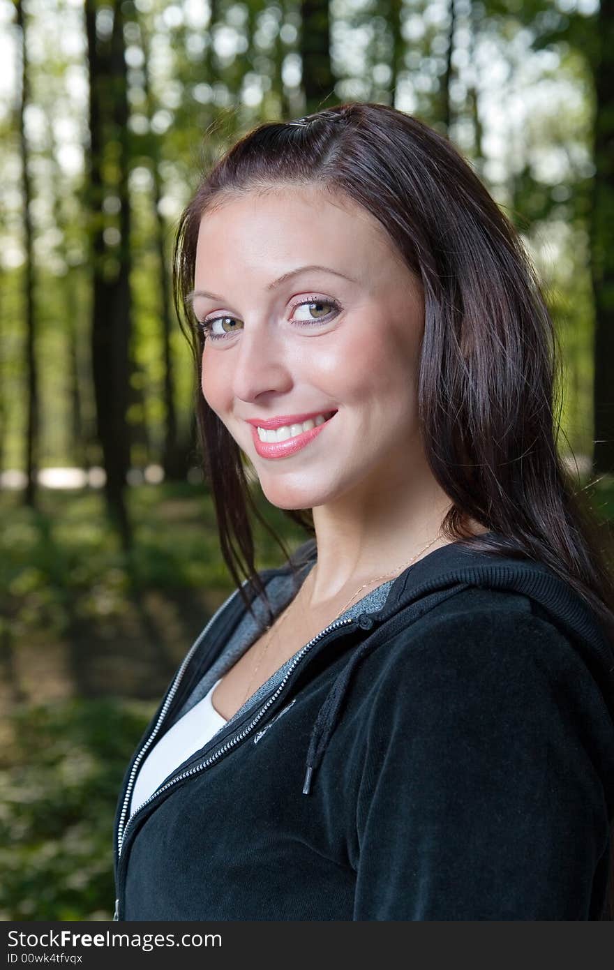 Smiling young woman on a background of forest. Smiling young woman on a background of forest.