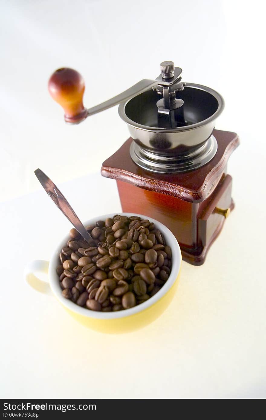 Coffee beans cup and old coffee grinder. Coffee beans cup and old coffee grinder