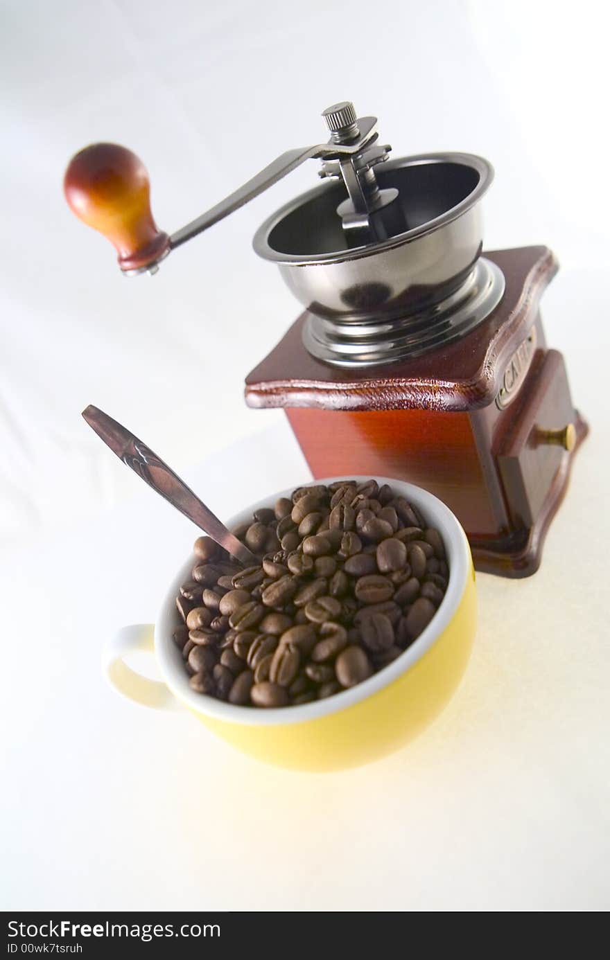 Coffee beans cup and old coffee grinder. Coffee beans cup and old coffee grinder