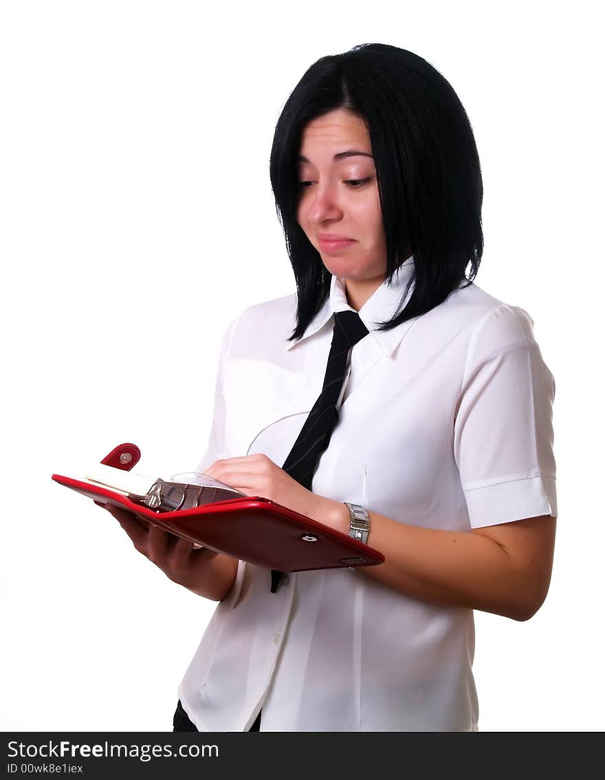 A portrait about a young attractive businesswoman with black hair who is holding a red calendar, she is sad because her agenda is full. She is wearing a white shirt and a black tie. A portrait about a young attractive businesswoman with black hair who is holding a red calendar, she is sad because her agenda is full. She is wearing a white shirt and a black tie.