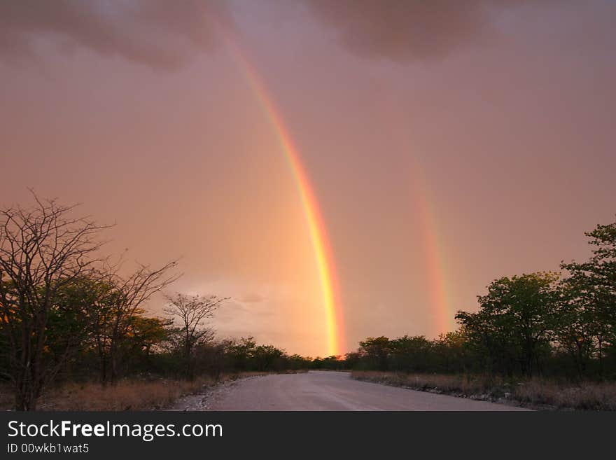 Dramatic stormy sky with rainbow over the Etosha national park. Namibia. Dramatic stormy sky with rainbow over the Etosha national park. Namibia.