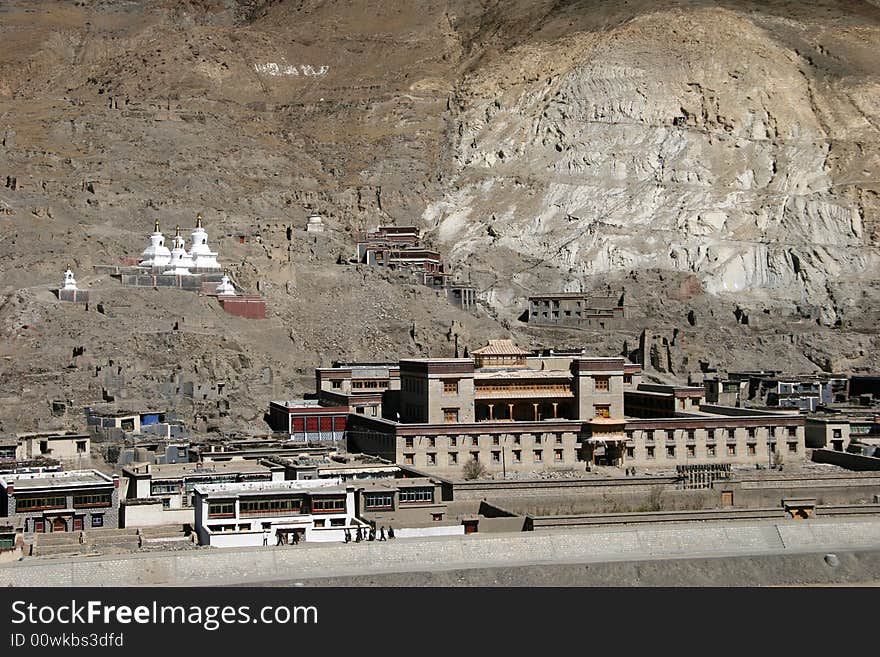 Buddist monastery - Tibetan stupas above the village in mountains. Tibet