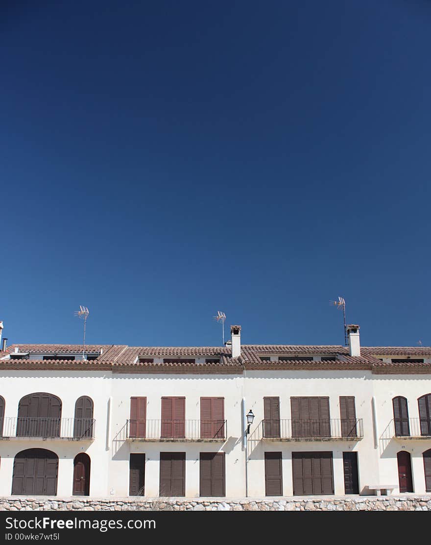 Boardwalk of houses behind blue sky without clouds. Boardwalk of houses behind blue sky without clouds