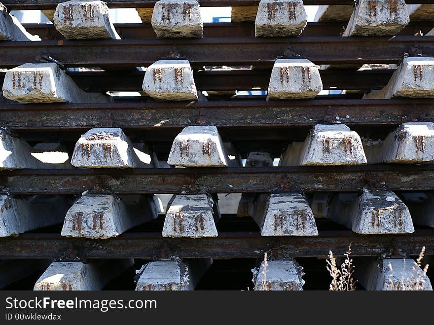 Concrete bars with railways in a pile at a construction site