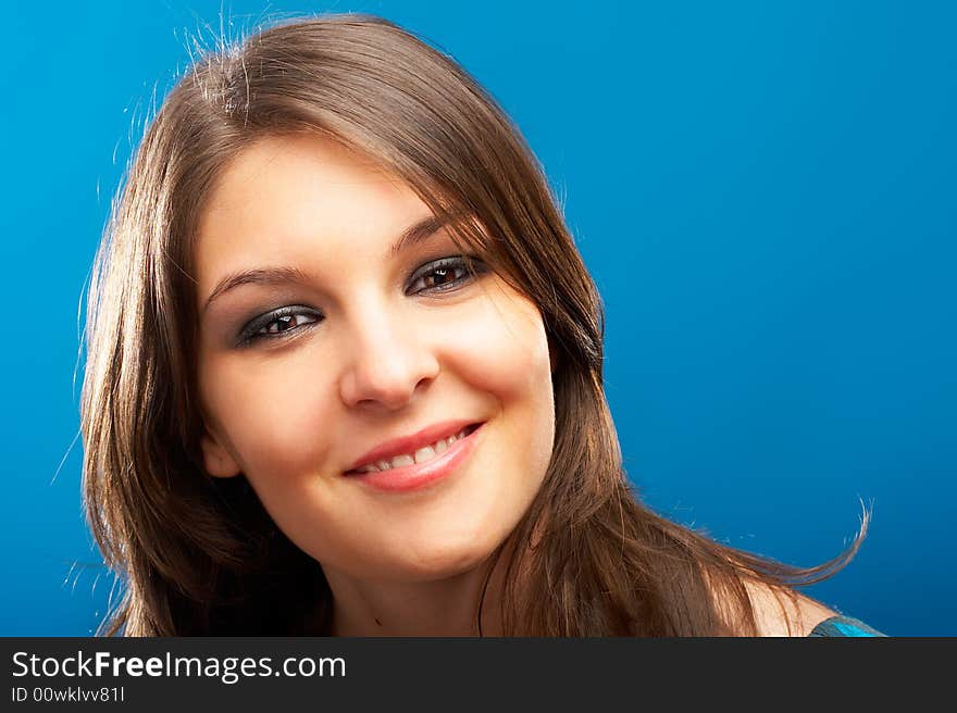 Beautiful Fashion Model shot in studio over blue background