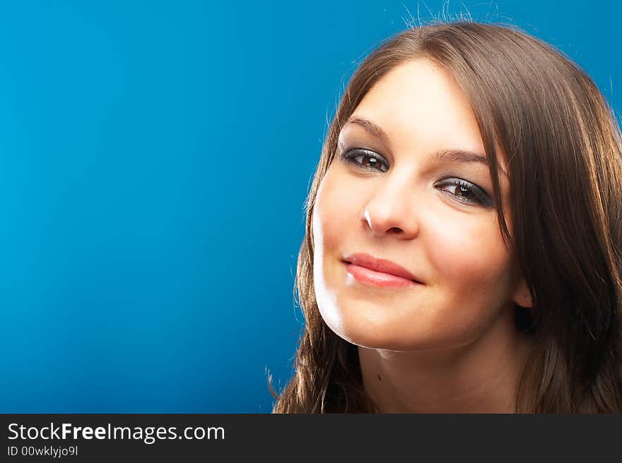 Beautiful Fashion Model shot in studio over blue background