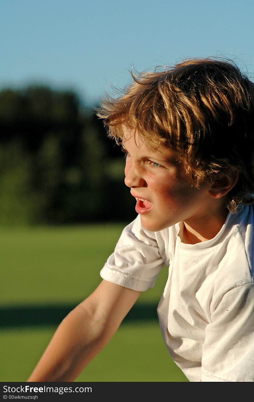 Close-up candid portrait of boy playing sport at park. Close-up candid portrait of boy playing sport at park