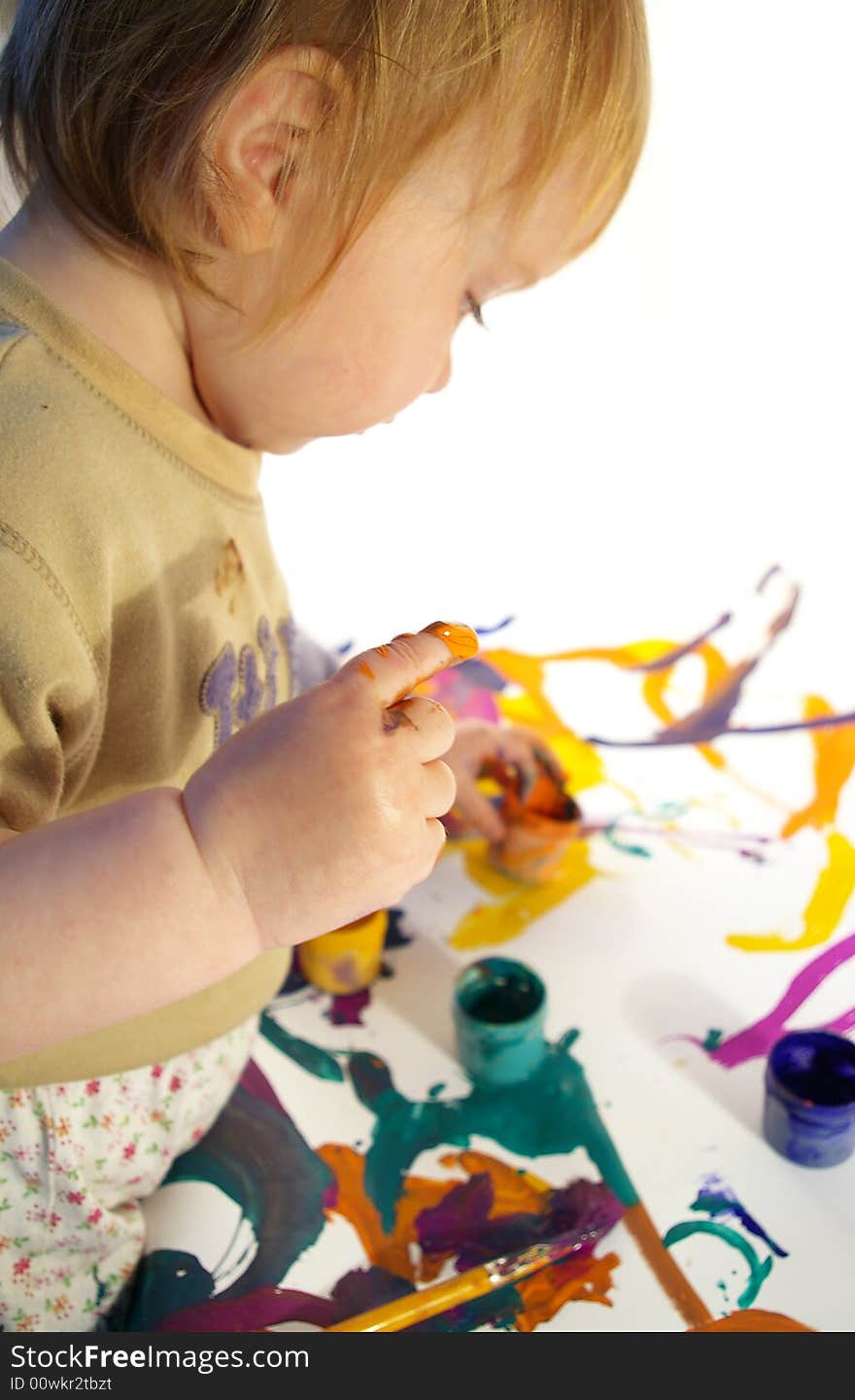 The little girl draws on a paper isolated. The little girl draws on a paper isolated