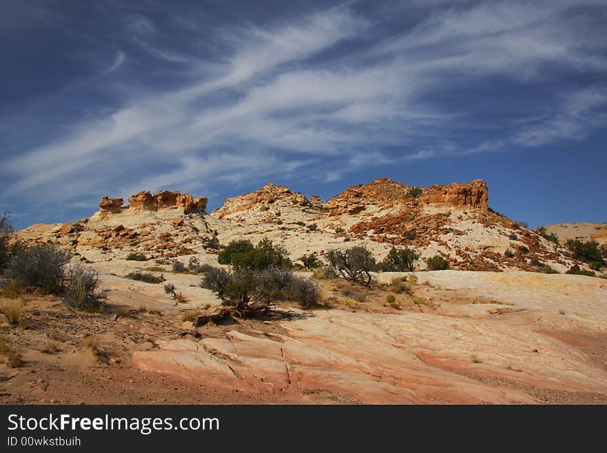 View of the red rock formations in San Rafael Swell with blue sky�s and clouds. View of the red rock formations in San Rafael Swell with blue sky�s and clouds