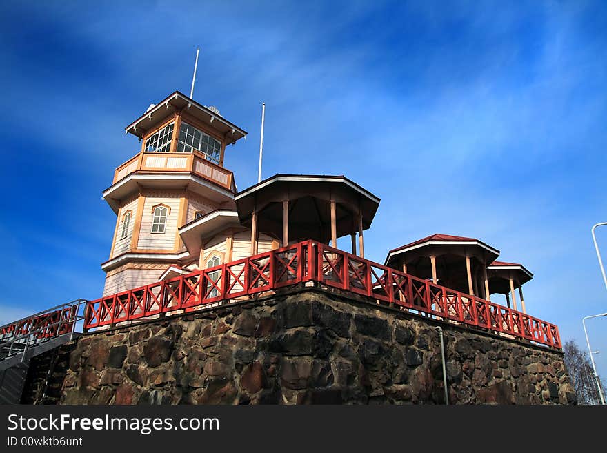 Wooden building in sunshine against blue sky, Finland. Wooden building in sunshine against blue sky, Finland