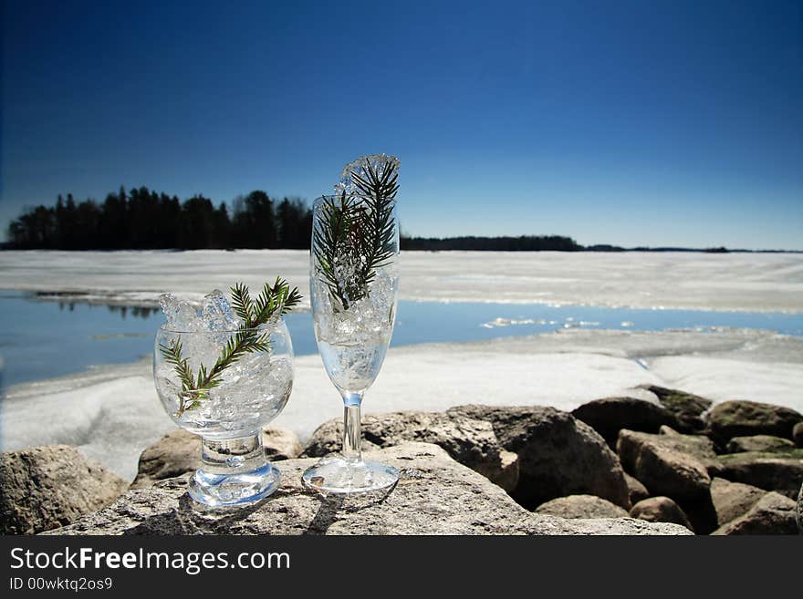 Glasses with ice on the edge of a frozen lake