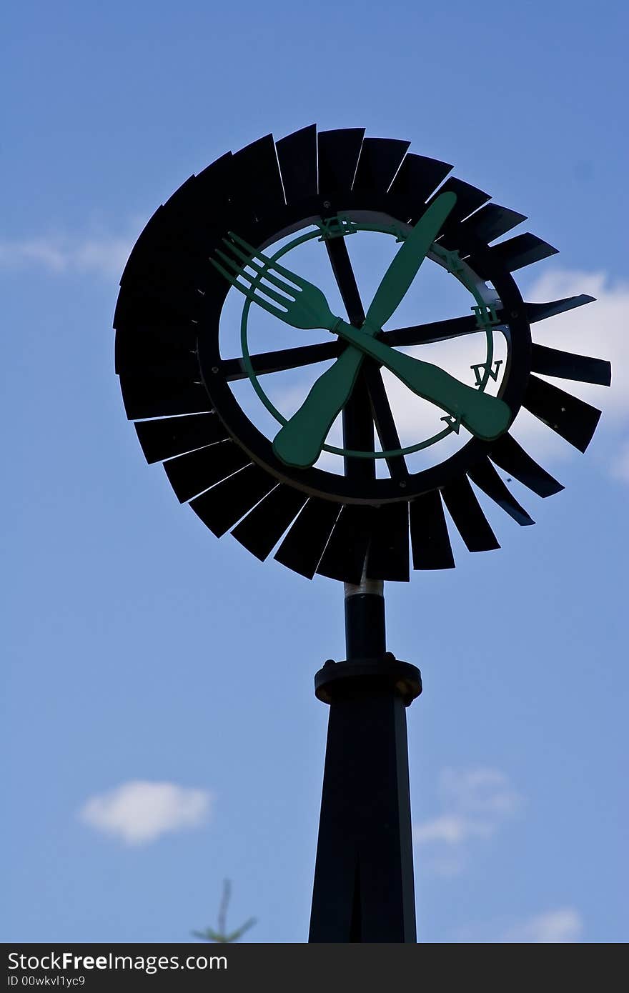 Old windmill against a blue sky nice green background image. Old windmill against a blue sky nice green background image