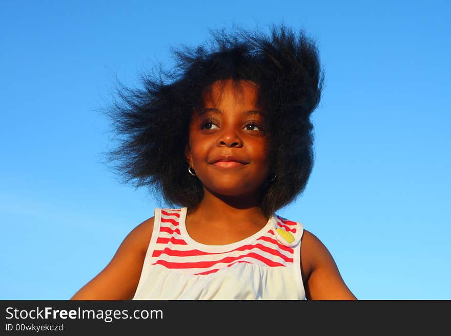 Young girl in the wind with hair blowing around.