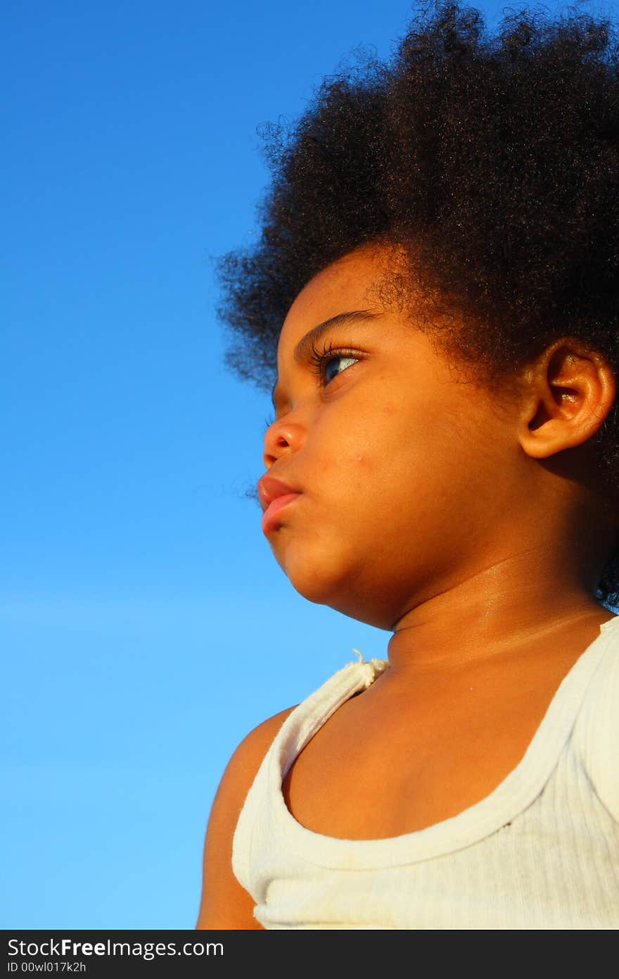 Young child with a blue sky background which could be used for copyspace. Young child with a blue sky background which could be used for copyspace.