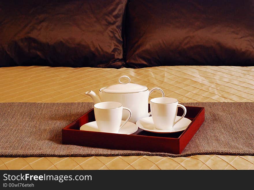 Tea Set on the bed of a posh room. Tea Set on the bed of a posh room