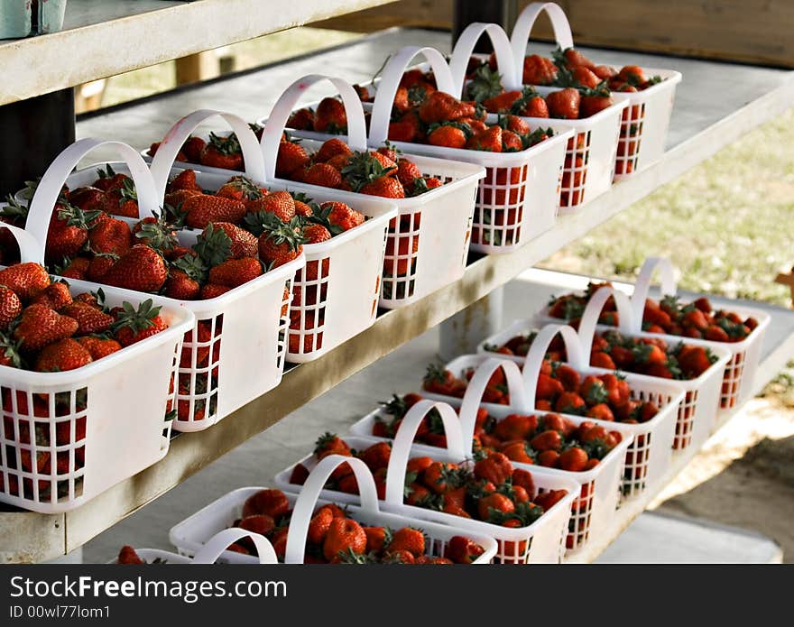 Fresh strawberries in baskets at a farmers market