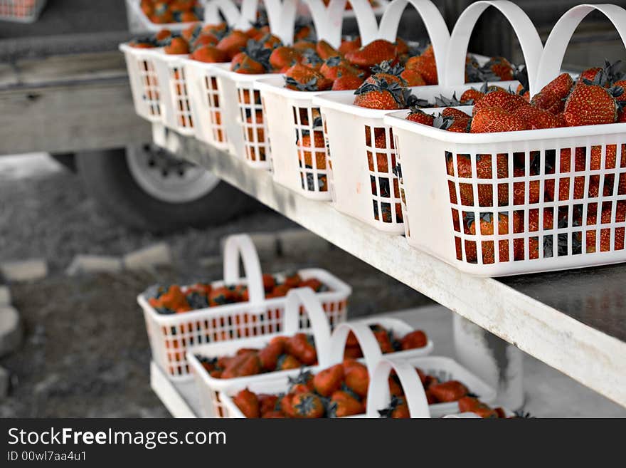 Fresh strawberries in baskets at a farmers market