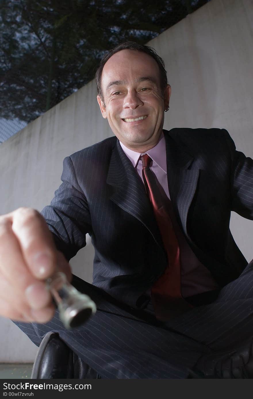 A close-up shot of a businessman playing with chess pieces, sitting cross-legged. A close-up shot of a businessman playing with chess pieces, sitting cross-legged.